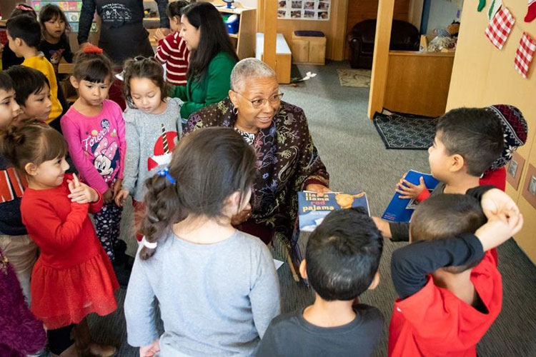 SAC President Dr. Linda Rose and RSCCD Trustee Claudia Alvarez handing out books