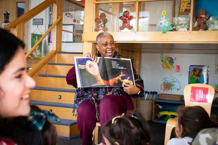 SAC President Dr. Linda D. Rose reading Llama Llama Red Pajama by Anna Dewdney to children