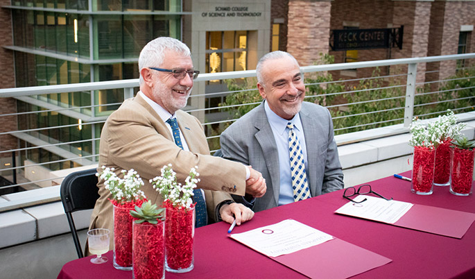 Image of Chapman President Dr. Daniele C. Struppa and SCC President Dr. John Hernandez shaking hands